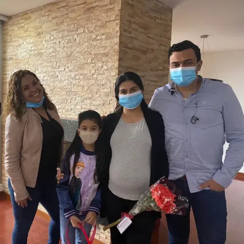 Elida López with her clients celebrating the handover of their home
