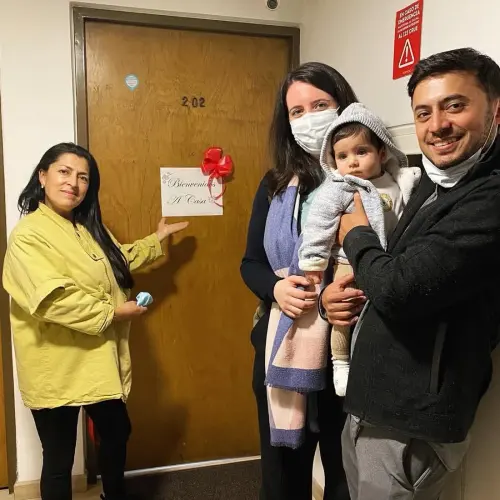 Elida López with her clients celebrating the handover of their home